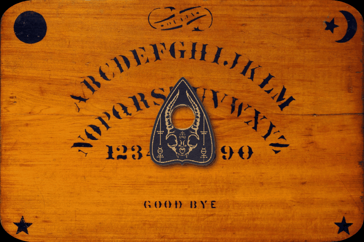 The planchette spelling LOVE ONE ANOTHER on the Ouija board